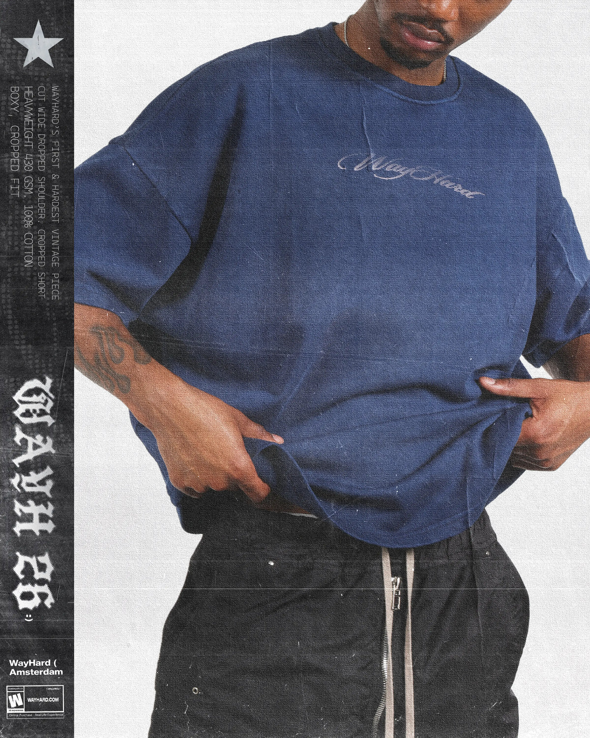 A person wearing an oversized wayhard blue t-shirt with 'Niggster' written in white script on the chest, paired with black pants. The image has a vintage, grunge aesthetic with a black vertical banner on the left containing text and a star logo.